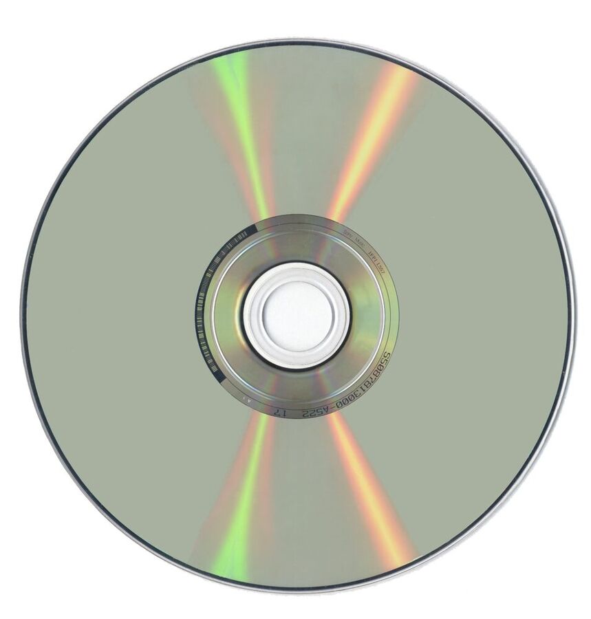 The shiny underside of a DVD disc reflecting bands of rainbow colours