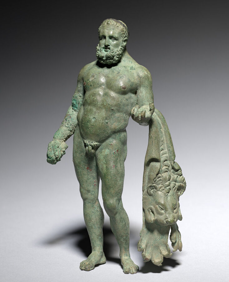Small green bronze statuette of a bearded, naked Hercules with a lion skin hanging from his arm