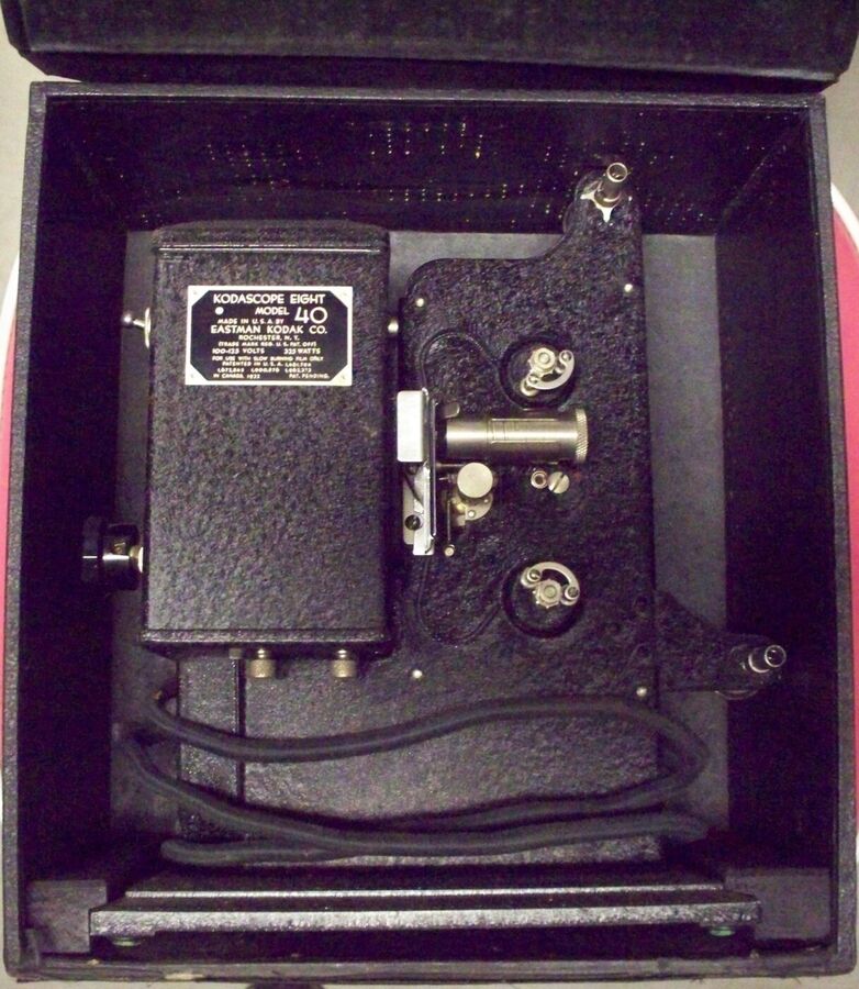Black Kodak 8mm film projector stored upright in its open carrying case