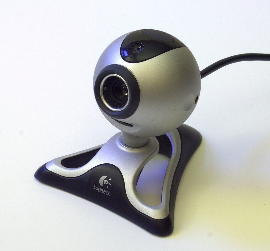 Small silver and black spherical webcam on a curved stand with a cable