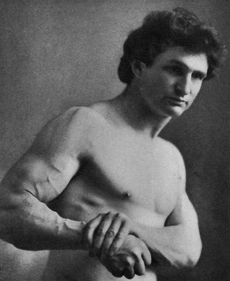 Photograph of Bernarr Macfadden, bare-chested, with folded arms and tensed muscles