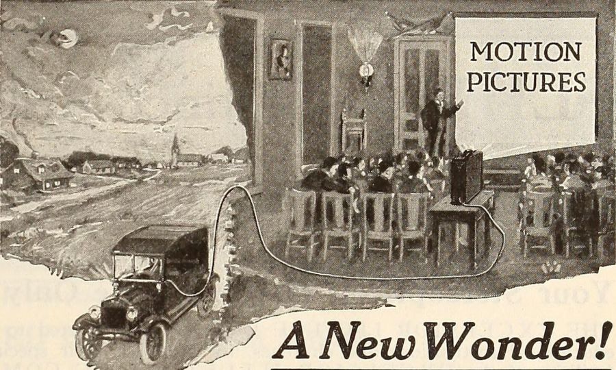 Illustration of a village hall where an audience watches a film from a small portable projector powered by a cable running from a car parked outside