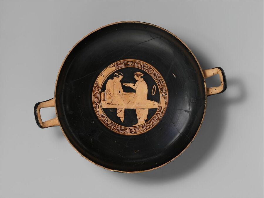 Red-figure drinking cup with two men seated in conversation in the central medallion