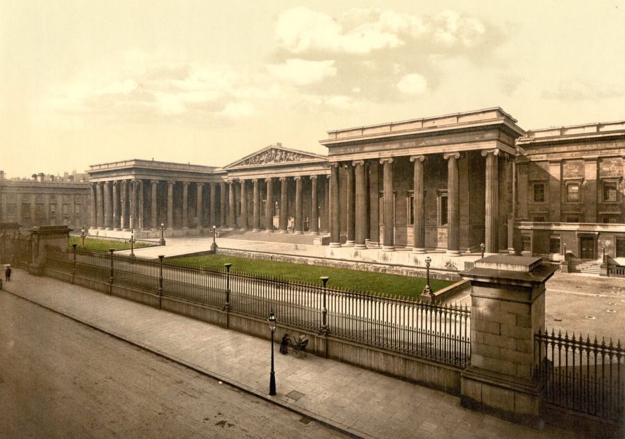 The colonnaded front of the British Museum seen from the street, behind iron railings