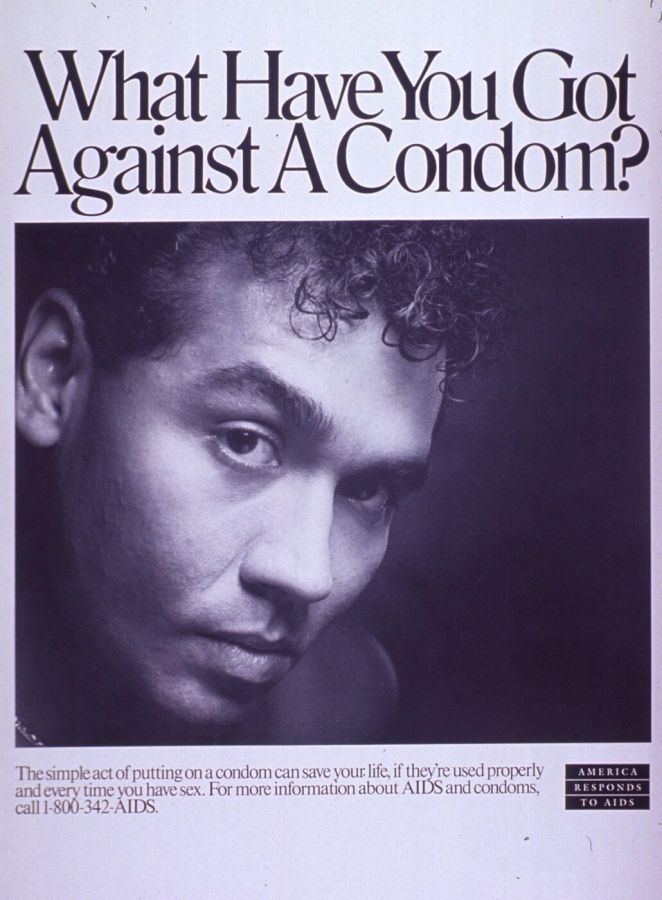 Black and white poster with the headline What Have You Got Against A Condom? above a close-up portrait of a young man with dark curly hair