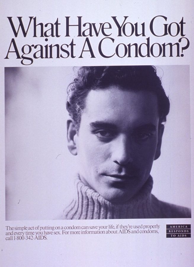 Black and white poster with the headline What Have You Got Against A Condom? above a portrait of a young man in a polo-neck jumper