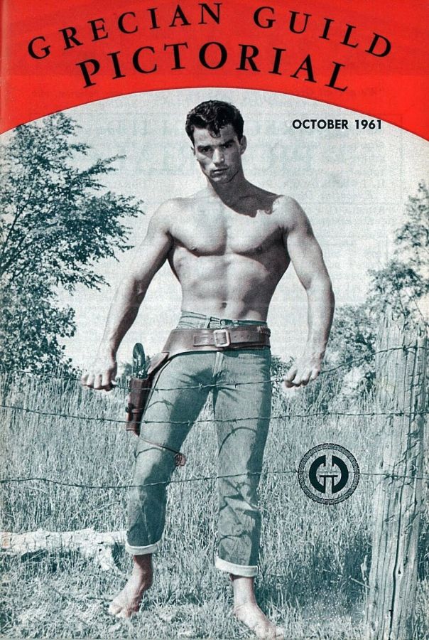 Magazine cover with the title Grecian Guild Pictorial in a red band, showing a shirtless muscular man in jeans and a gun belt standing barefoot by a wire fence in long grass
