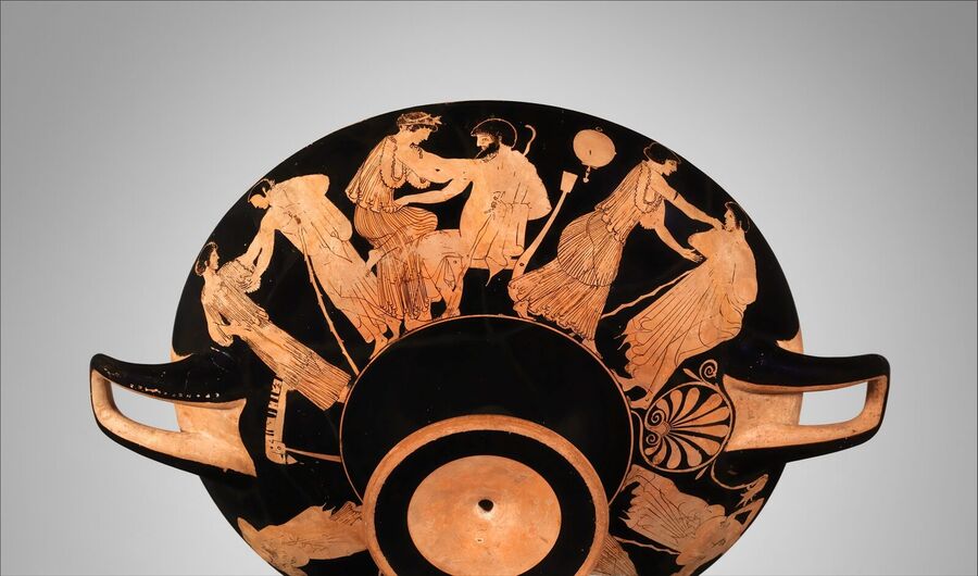 Underside of a red-figure drinking cup with men and women in long robes painted around its outer wall, one bearded man seated with a woman