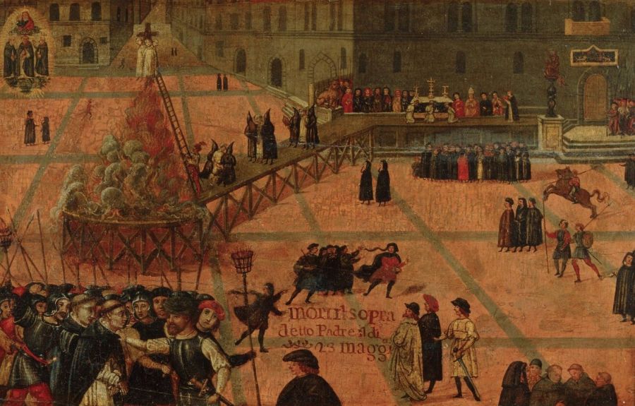 Panel painting of a large square in front of a fortified palace with a tower, crowded with small figures, with a raised walkway leading to a burning pyre