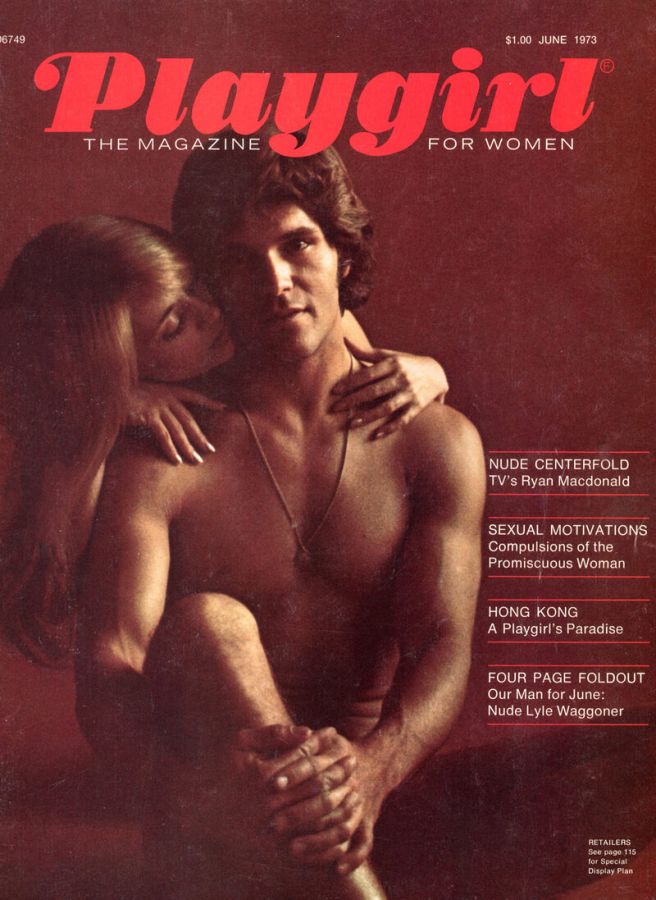 Magazine cover in dark red with the title Playgirl, The Magazine for Women, showing a dark-haired bare-chested man embraced from behind by a woman, with cover lines announcing a nude centerfold and a nude Lyle Waggoner