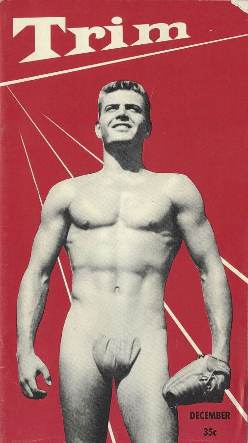 Red magazine cover with the title Trim, showing a smiling muscular man in a small posing pouch holding a glove, with the word December at the bottom