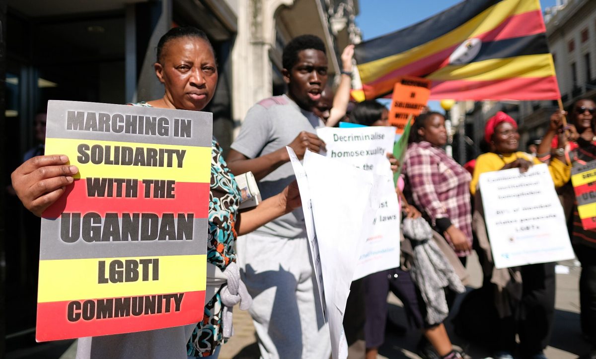 Demonstrators in London holding signs in solidarity with the Ugandan LGBTI community